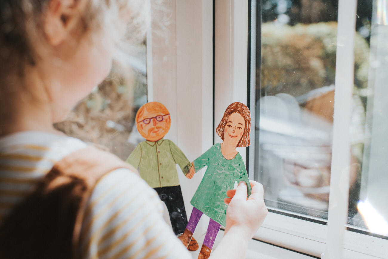 Little girl holding cut-out paper People