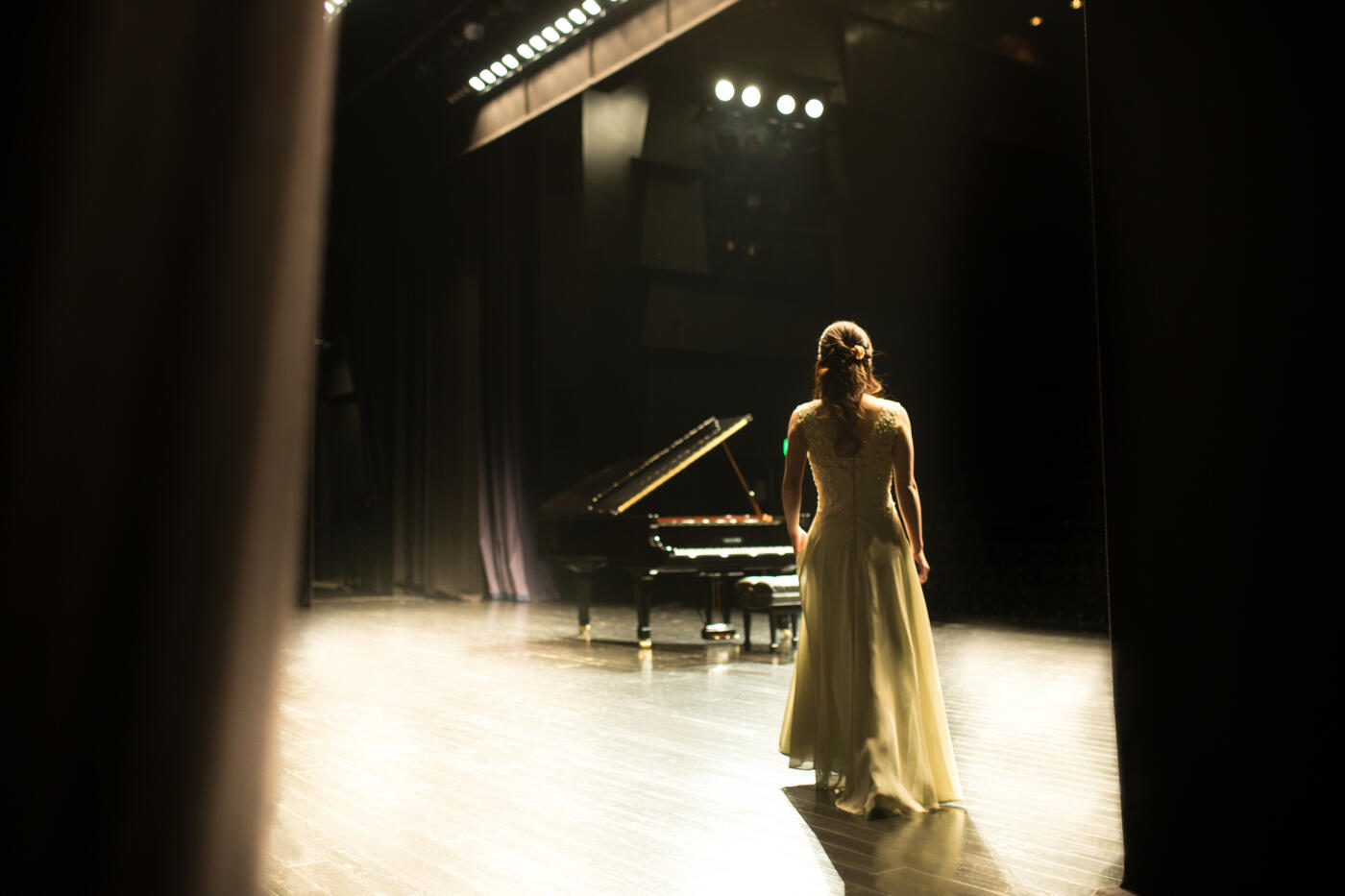 Woman walking to grand piano