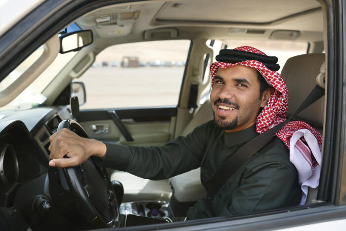 Portrait of Young Middle Eastern man in SUV driver’s seat