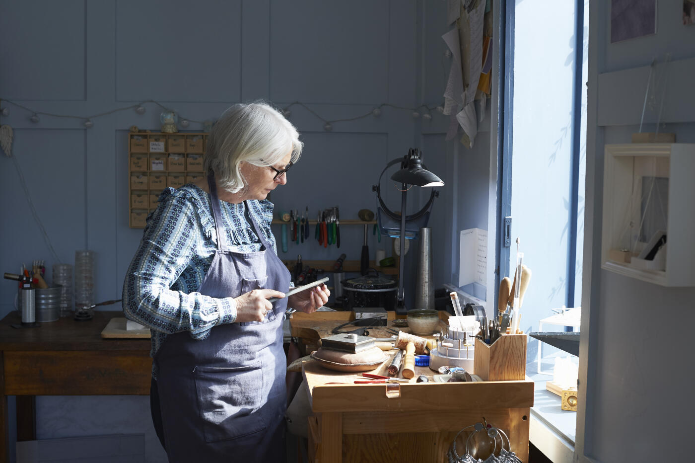 A jewellery maker using a rasp to make handmade artisanal jewellery