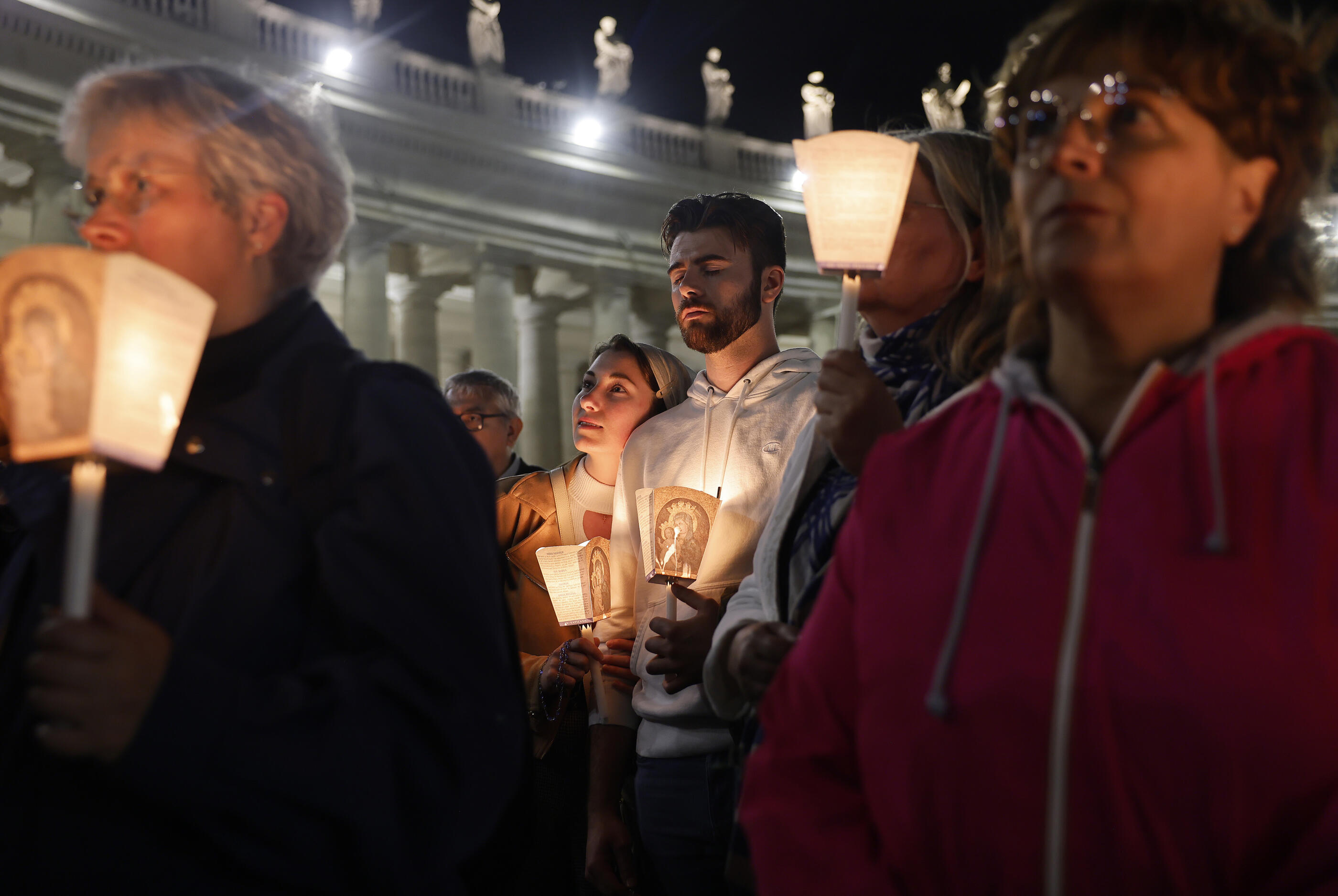 VATICAN CITY, VATICAN - MAY 03: The faithful participate in the Ma candlelight Rosary Procession around St Peter's Square on May 03, 2025 in Vatican City, Vatican. Funeral rites for the late Pope Francis are held for nine days after his burial as he is mourned and celebrated by the faithful. During this time, the Vatican prepares for the process to elect a new Pope, known as the Conclave, which must begin within 15 to 20 days of the Pope's death.  (Photo by Mario Tama/Getty Images)