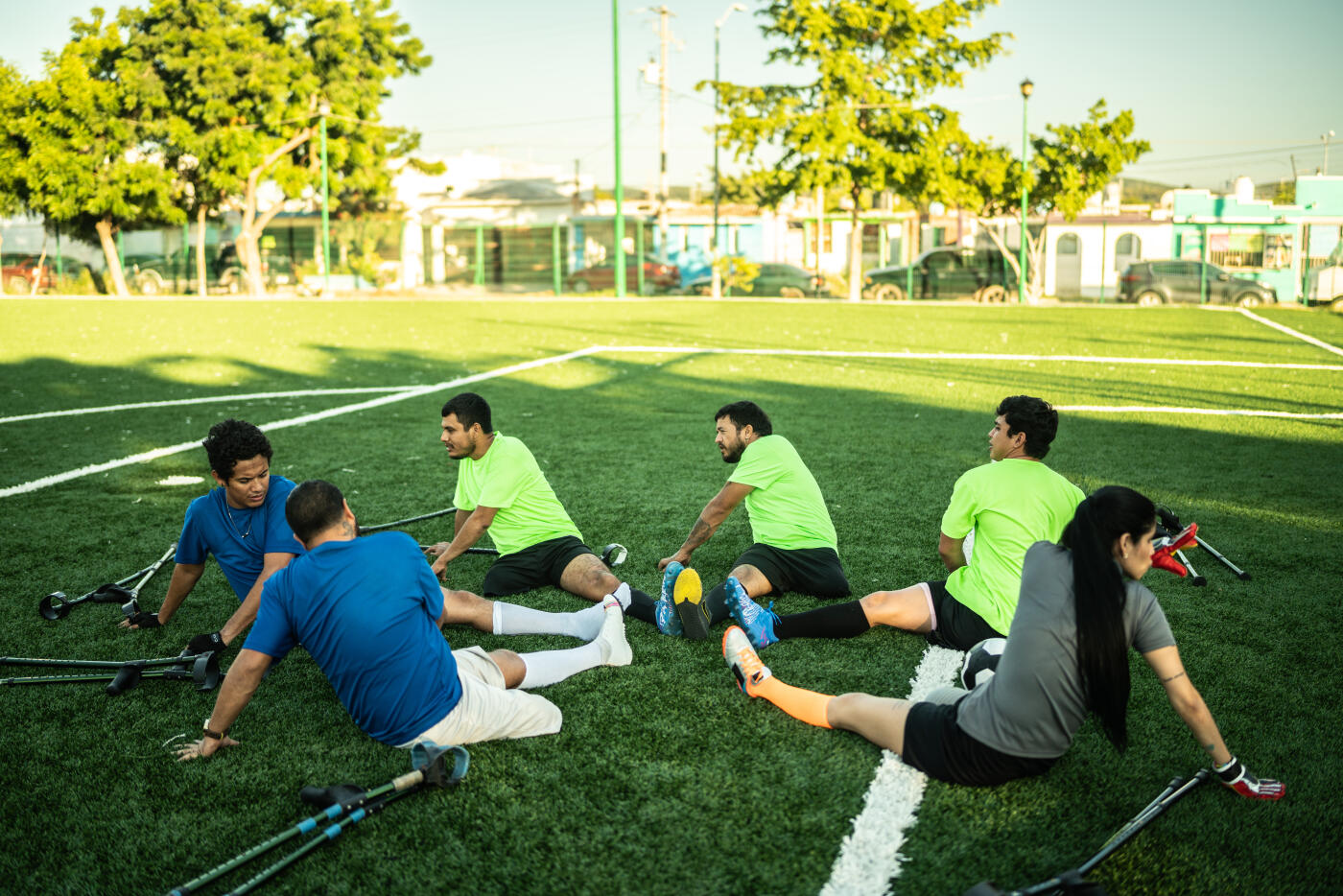 Amputee soccer players stretching on soccer field