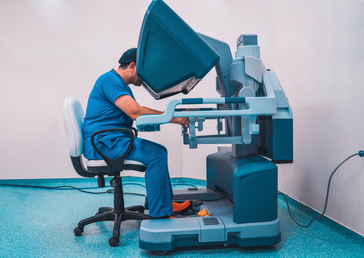 Robotic surgical system in hospital. Doctor posing with robotic surgical system.