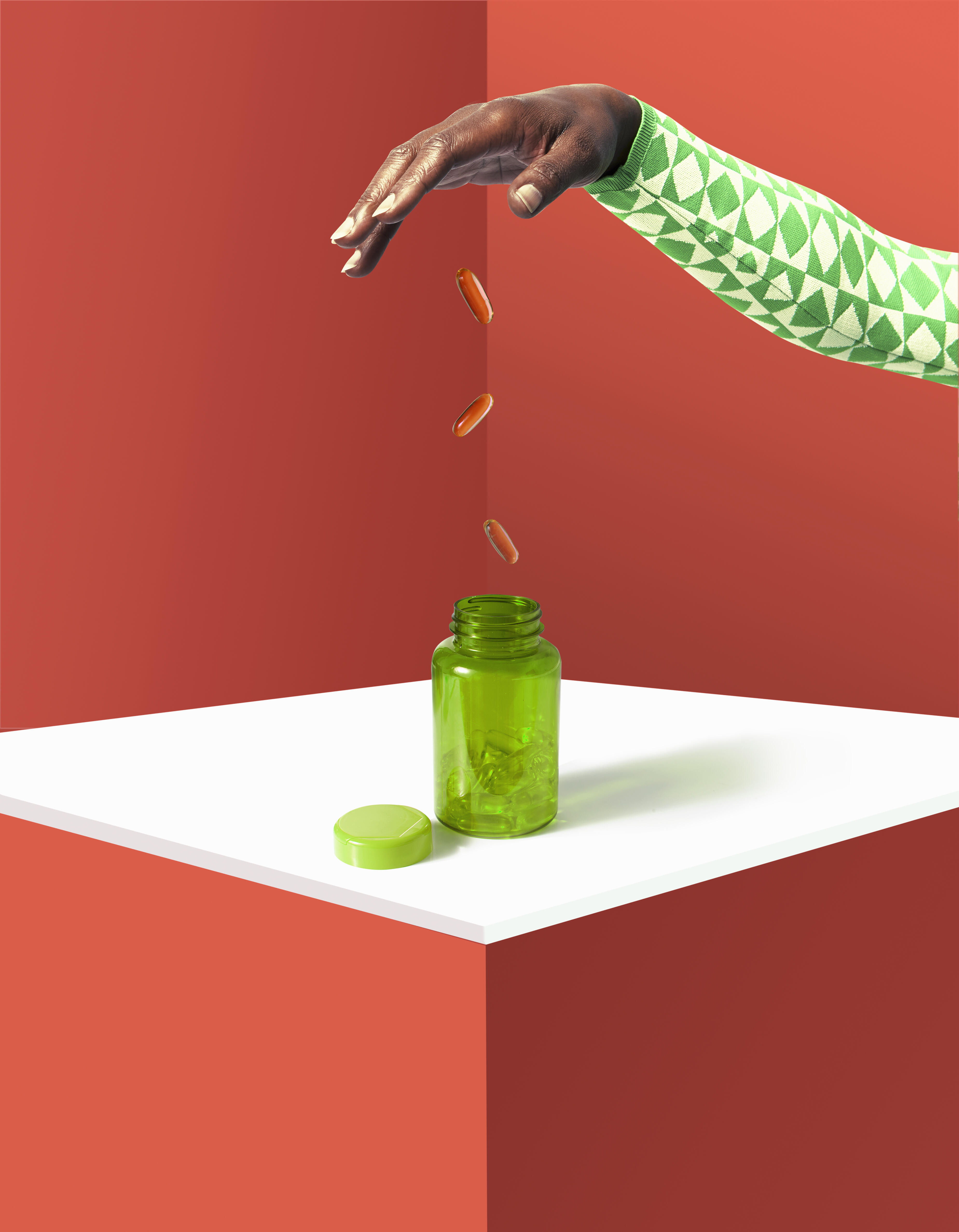 hand pouring coins into tablet bottle