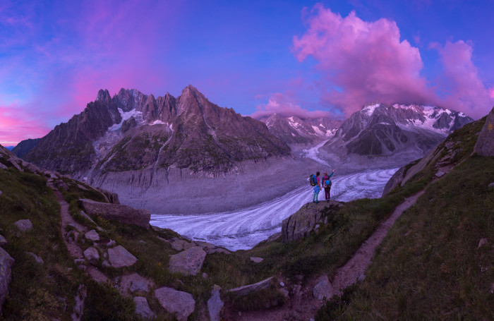 Climbers looking at majestic mountain sunset