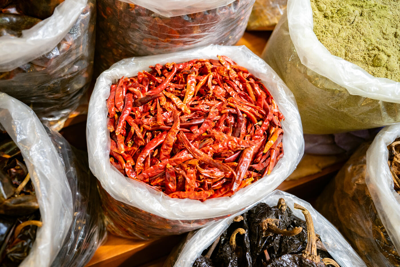 Mexican market stall selling dry chiles and condiments in bulk