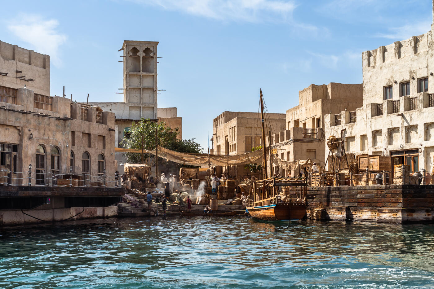 This sunny view from an abra on the Dubai Creek features the traditional architecture in Al Fahidi Historical Neighbourhood. Among the architectural features are wind towers, which were designed to cool the interior.