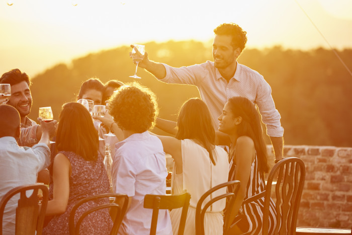 Man toasting wineglass with friends at party