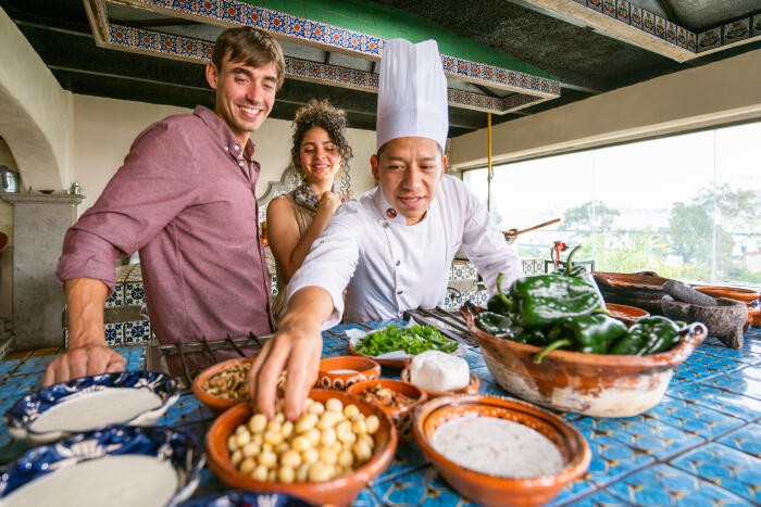 Chef shows tourists how to cook Mexican dish