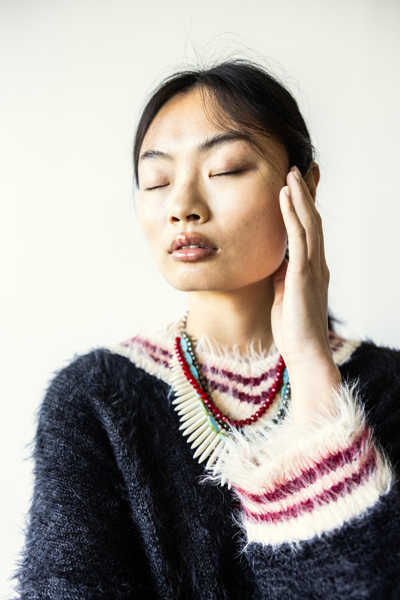 Portrait of fashionable young woman on white background