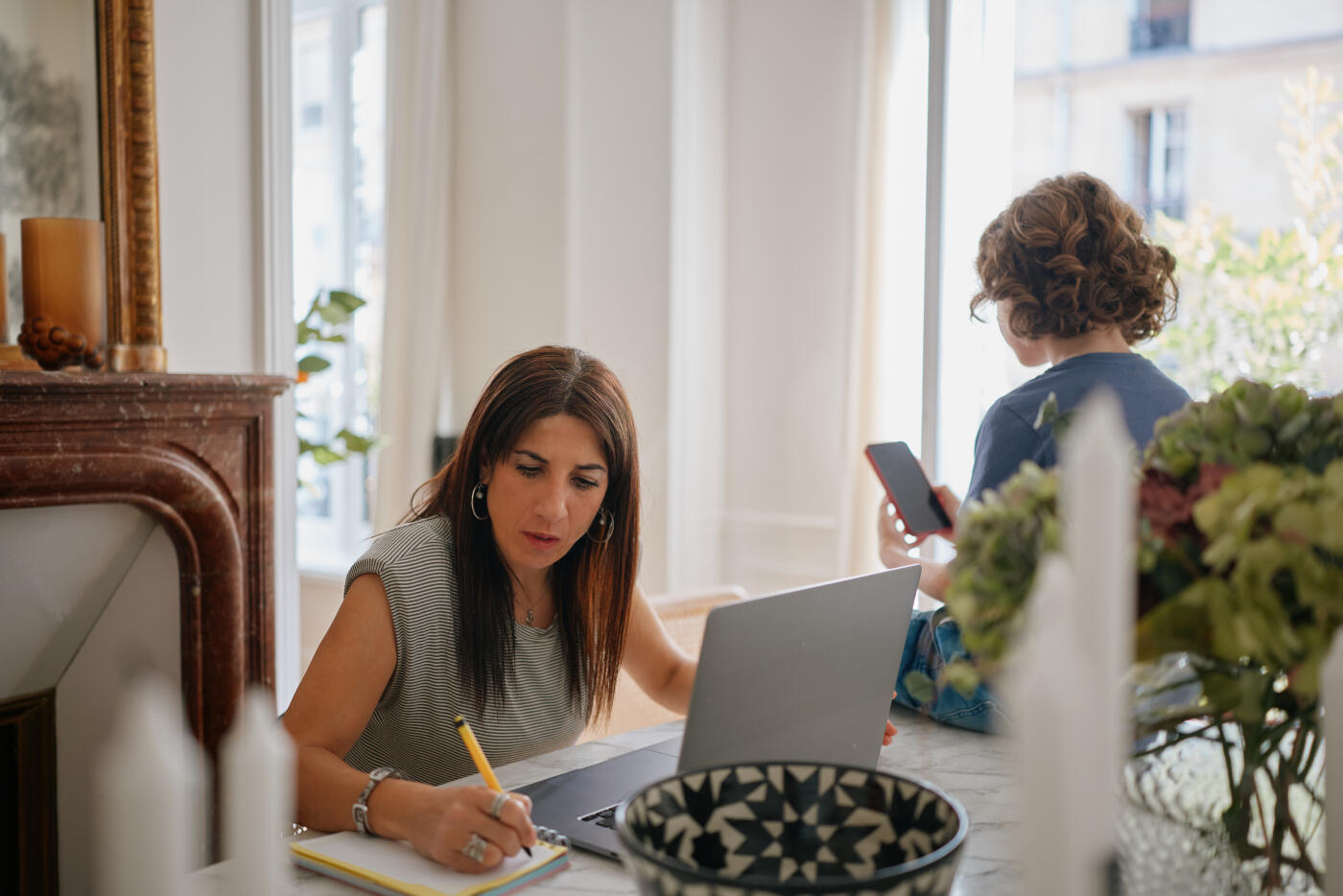 Mother Multitasking Between Work and Parenting at Home