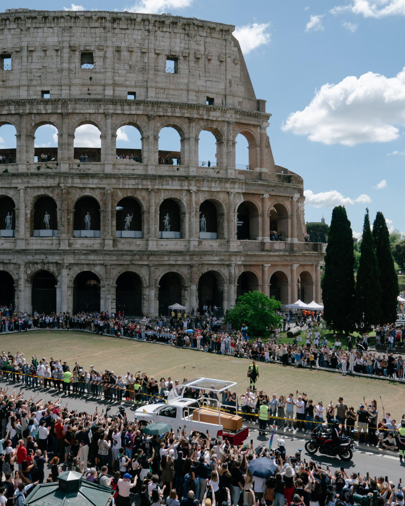 ROME, ITALY - APRIL 26: (EDITORS NOTE: This is a re-crop of image 2211432278)  A vehicle carrying the coffin of the late Pope Francis drives by the Colosseum on April 26, 2025 in Rome, Italy. Pope Francis died on April 21st at the age of 88. Born in Argentina as Jorge Mario Bergoglio, he was the first Latin American and the first Jesuit to become Pope when elected in 2013. Taking the name Francis after St Francis of Assisi, he promoted a more humble version of the papacy than many of his predecessors. He will be buried outside of the Vatican in a simple wooden coffin at the Basilica Santa Maria Maggiore. (Photo by Andrei Pungovschi/Getty Images)
