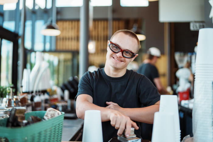 Teen with Down syndrome working at a coffee shop