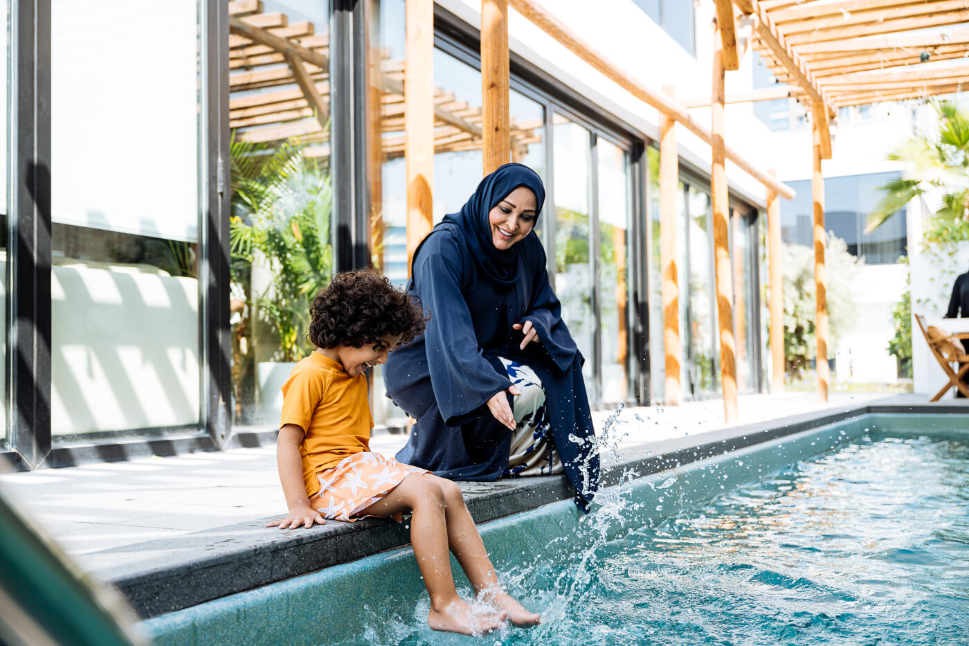 Parents with little boy enjoying holiday in luxury villas with swimming pools