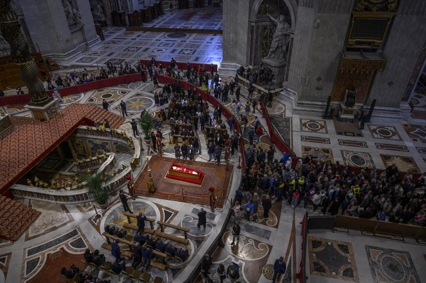 VATICAN CITY, VATICAN - APRIL 24: (EDITORS NOTE: Image depicts death) Faithful pay their respects as the body of Pope Francis lies in state inside St Peter's Basilica, on April 24, 2025 in Vatican City, Vatican. On the fourth day since his death was announced by the Vatican, the body of Pope Francis lies in state in a simple wooden coffin at the Basilica St Peter. His funeral will be held on Saturday, 26th April 2025. (Photo by Antonio Masiello/Getty Images)