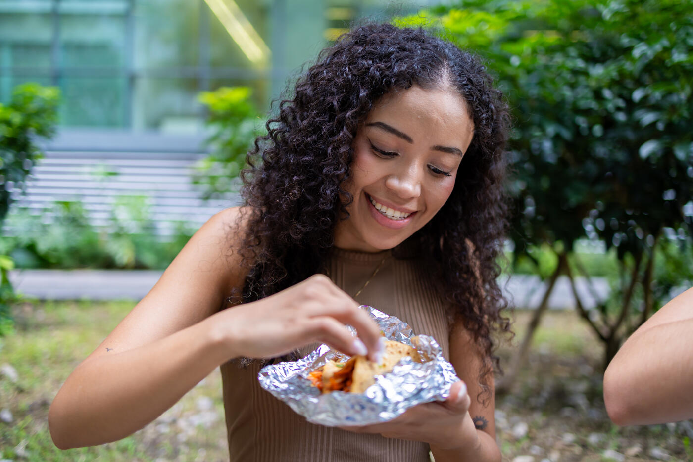 A woman enjoying her taco al pastor