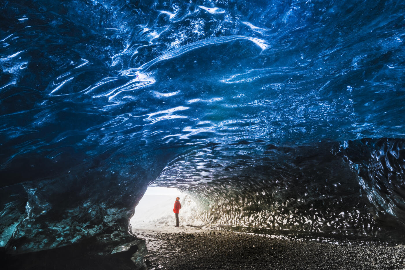 Man inside an ice caver under the Vatnajokull glacier, Vatnajokull national park, East Iceland, Iceland (MR)
