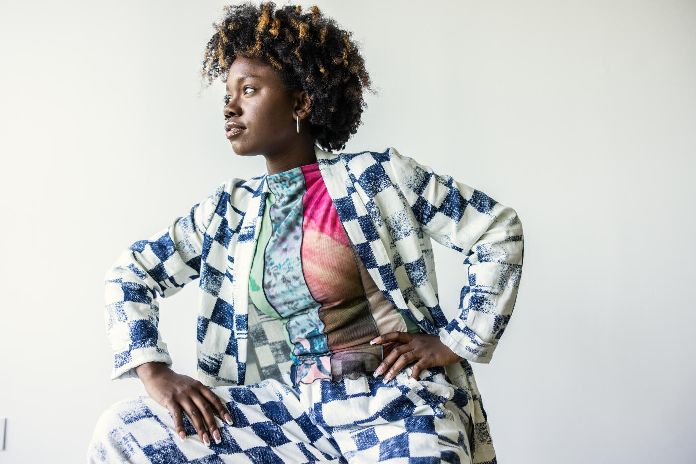 Portrait of fashionable young woman on white background