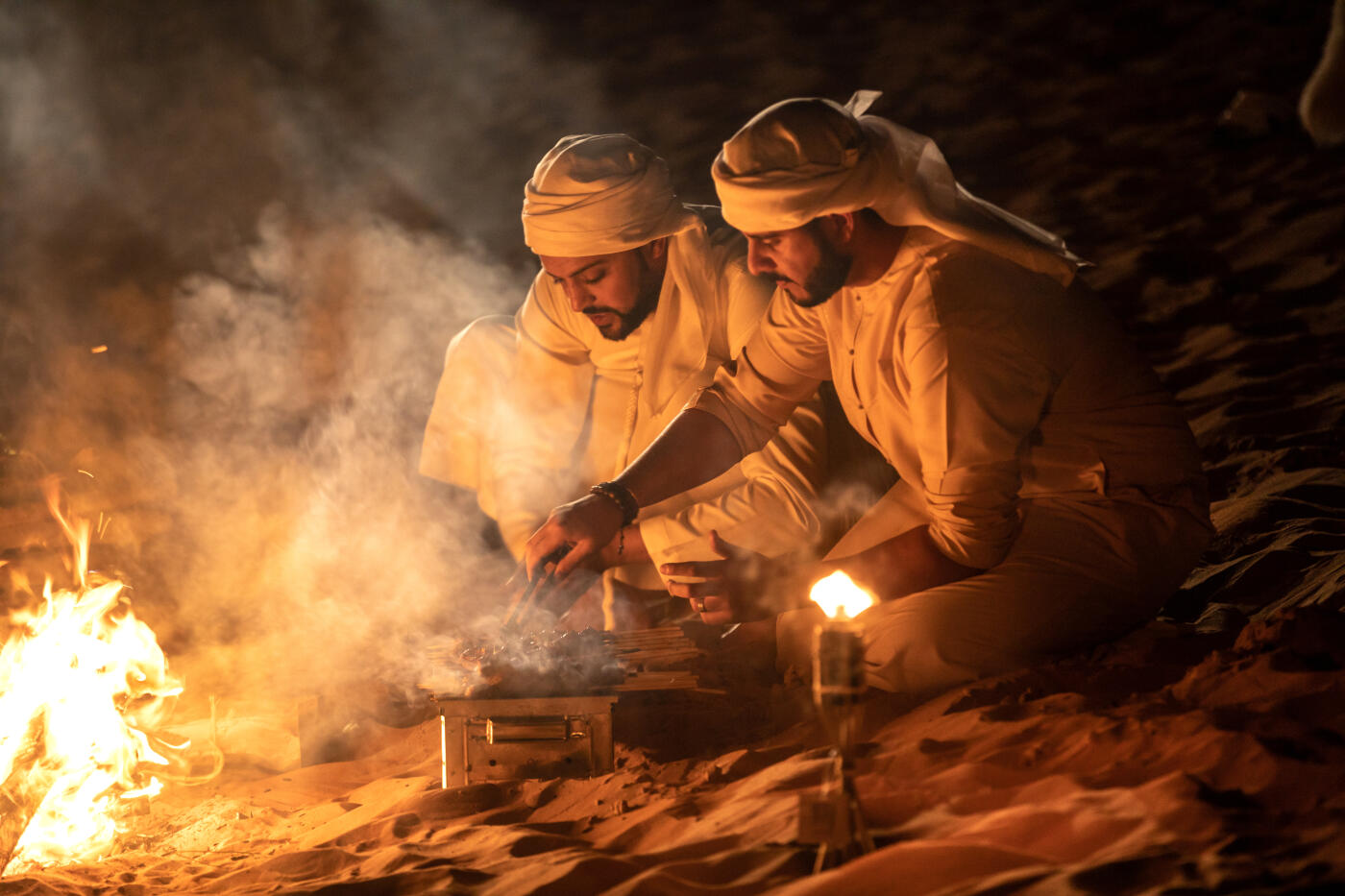 Arabs camping at night in the desert out of Dubai