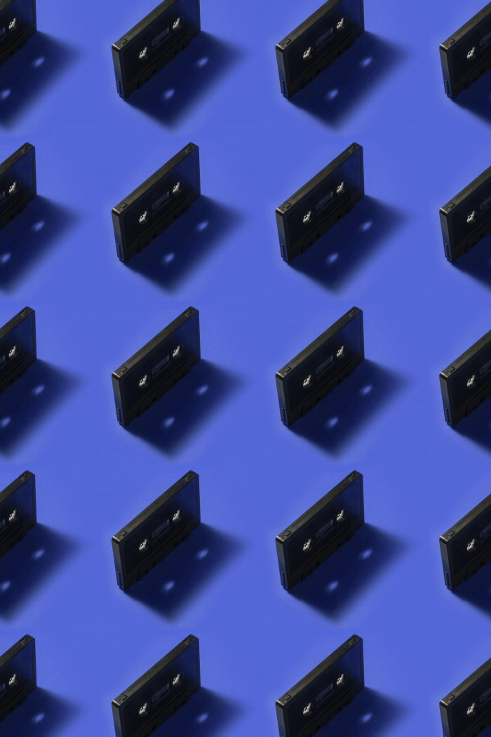 Cassette tapes repetitive pattern with navy blue background
