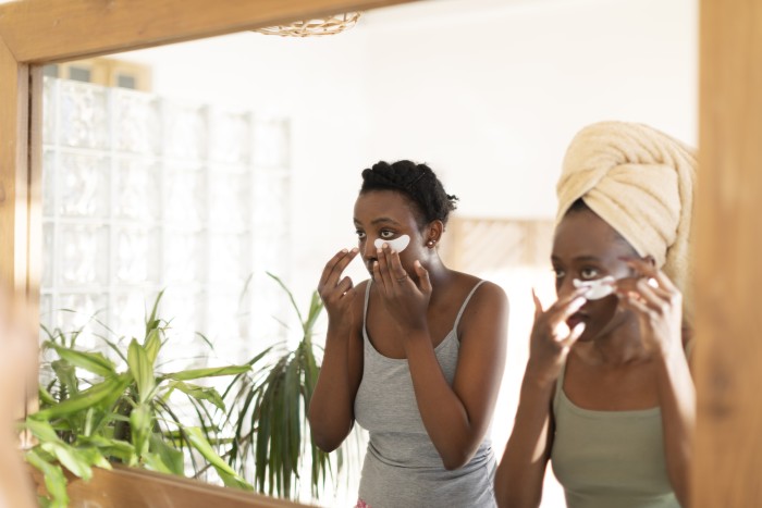 Two young African women using eye patch
