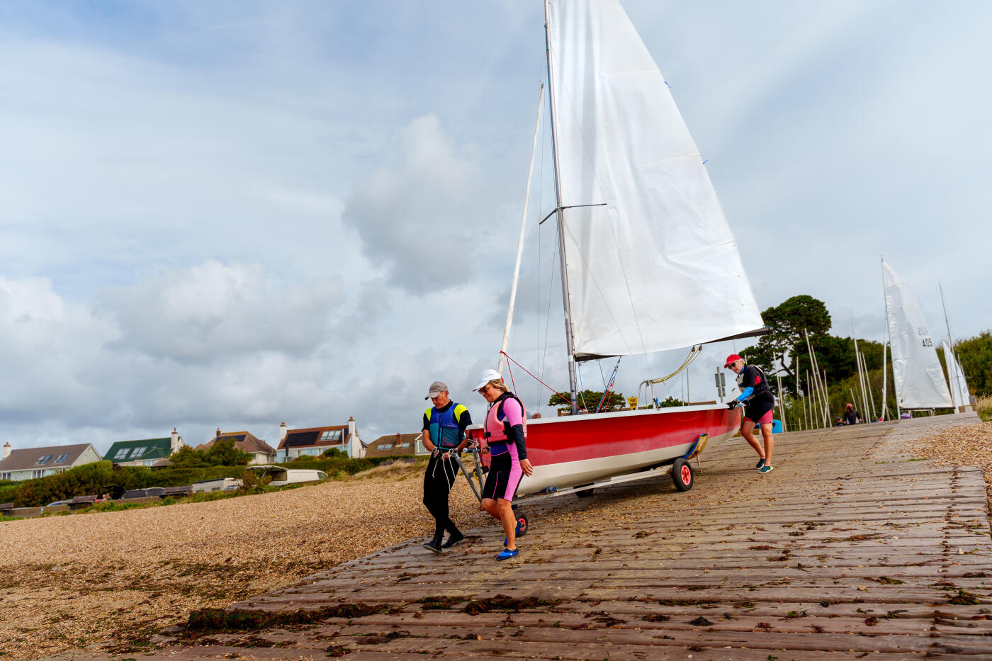 Senior man and senior woman Preparing his boat for a sailing race