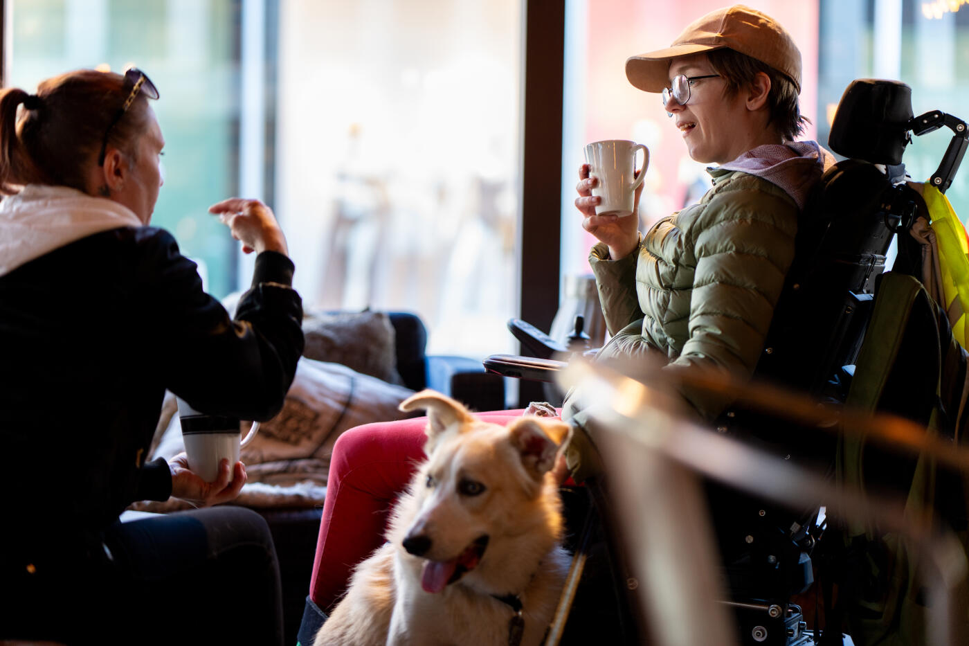Woman in wheelchair in cafe with friend