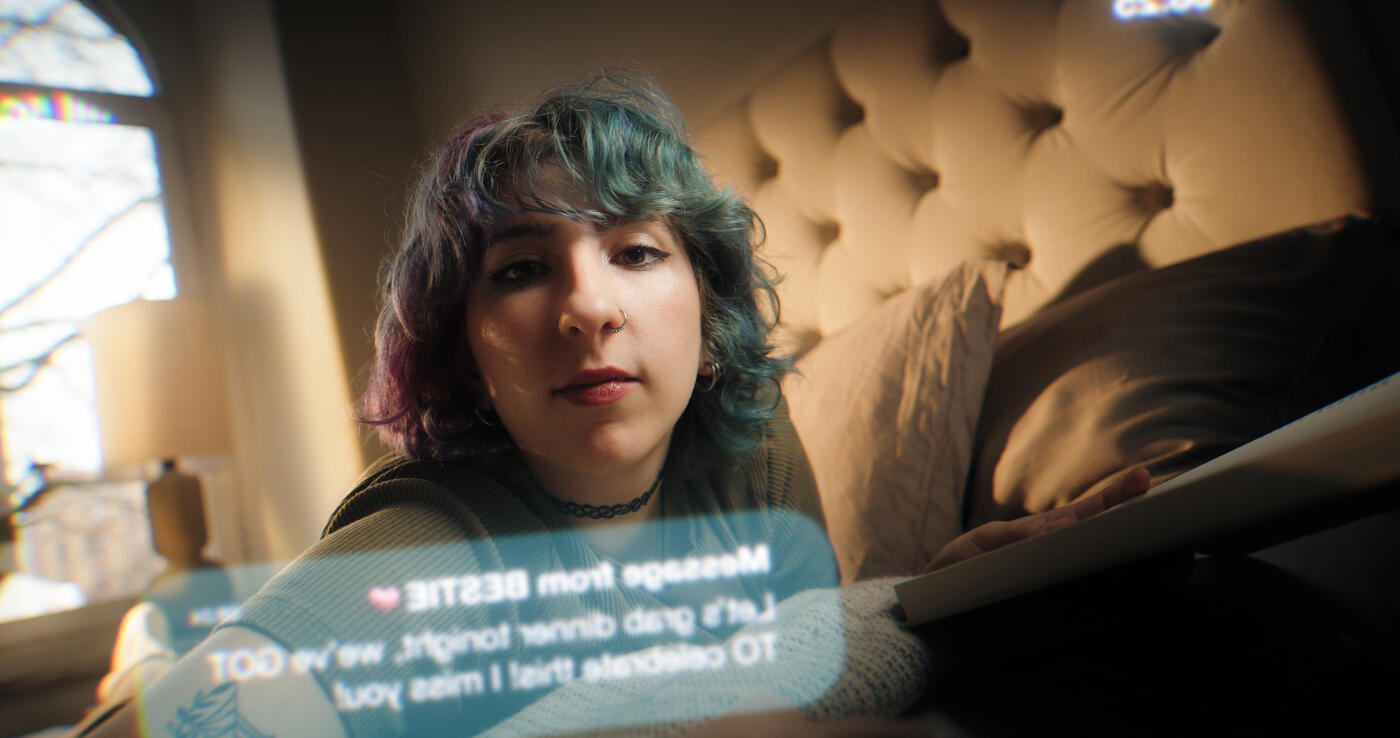 Woman reading in the bedroom. She is interrupted by a notification on her phone. Part of a series where a woman in her bedroom is seen through the screen of her smartphone.
