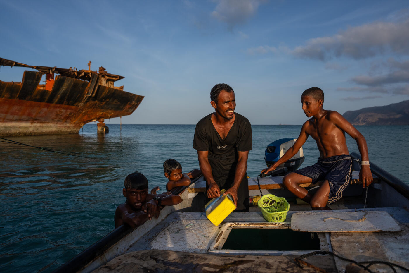 SOCOTRA ISLAND, YEMEN - OCTOBER 15: Boys swim in the sea next to a fisherman's boat on October 15, 2025 in Socotra, Yemen. Socotra island, sometimes referred to as the "Galapagos Islands" of the Indian Ocean, lies about 150 miles off the coast of the Horn of Africa and is home to 825 plant species, more than a third of which are only found here. Among them are the otherworldly dragon's blood tree, bottle trees and 11 species of frankincense, 4 of which were classified as critically endangered in March of this year. The intensifying tropical cyclones in this part of the Indian Ocean, fuelled by climate change, has put the island's unique ecosystem at risk. Meanwhile, Yemen's civil war - as well as the region-destabilizing attacks on commercial vessels in the Red Sea - have complicated conservation efforts. (Photo by Carl Court/Getty Images)