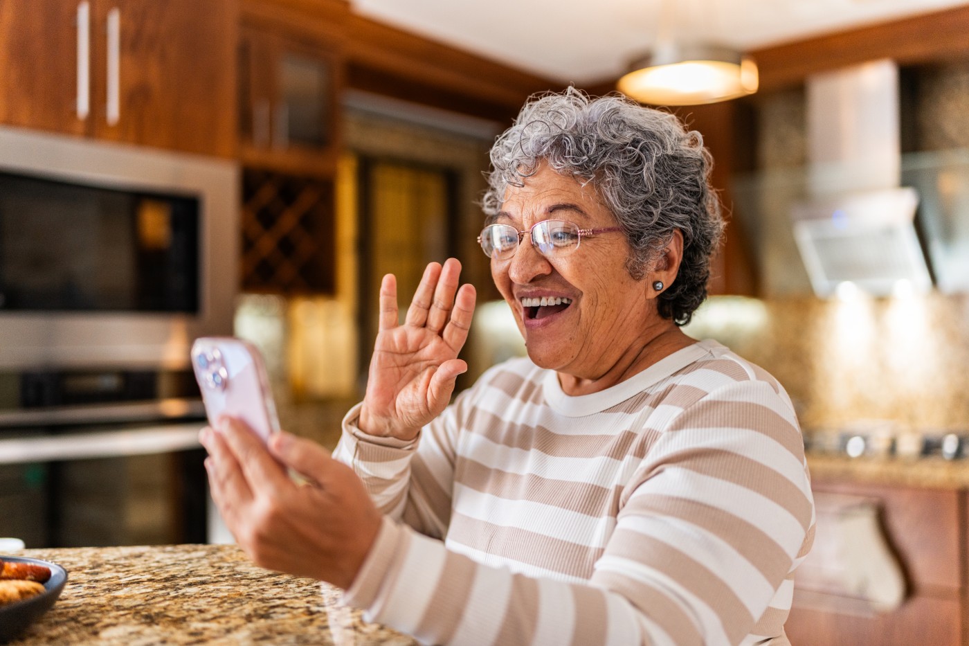 Senior woman talking on video call at home