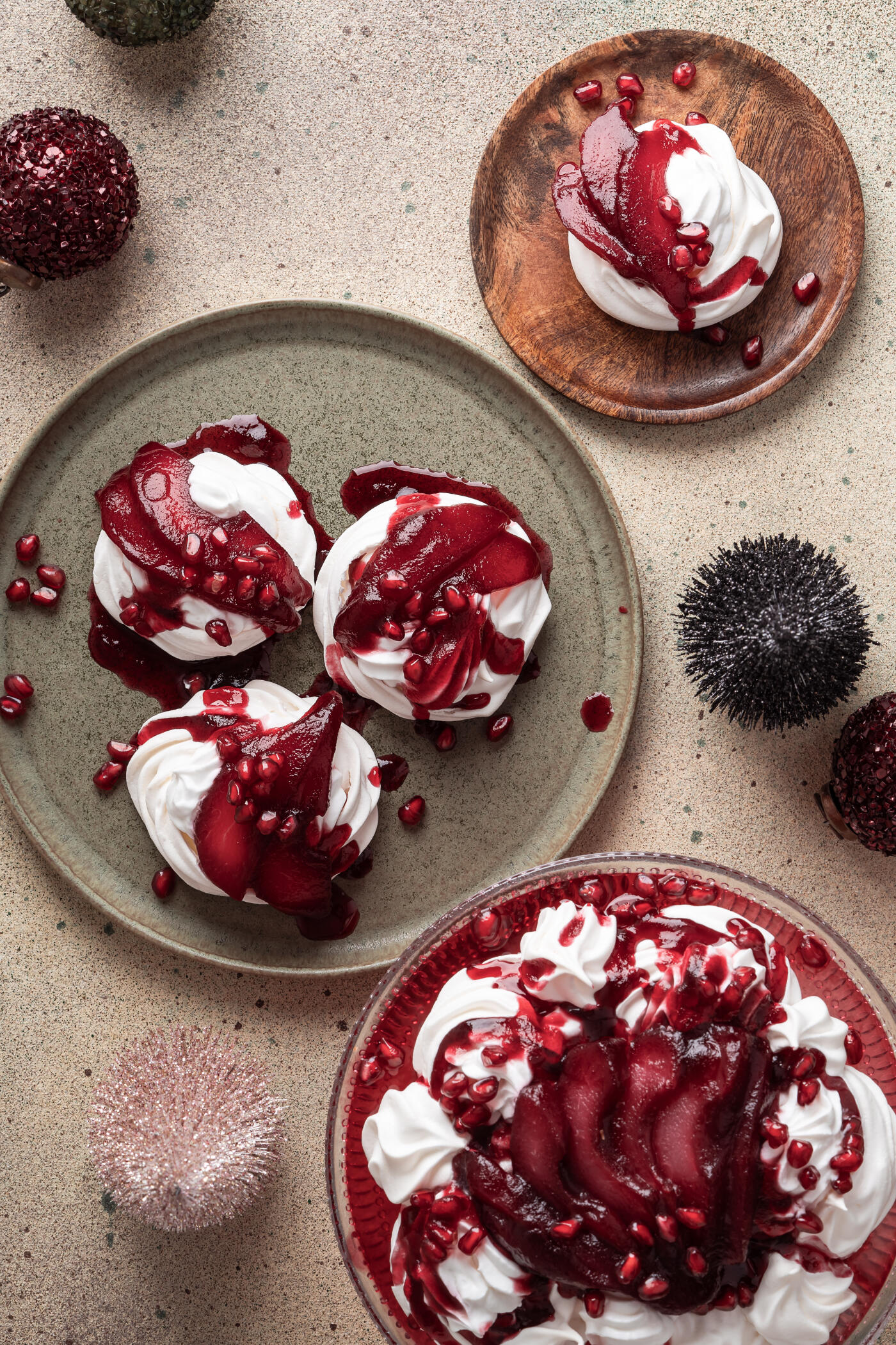 Pavlova with whipped cream, topped with hibiscus poached pears and pomegranate, delicious winter holiday dessert, Christmas pavlova crown, directly above