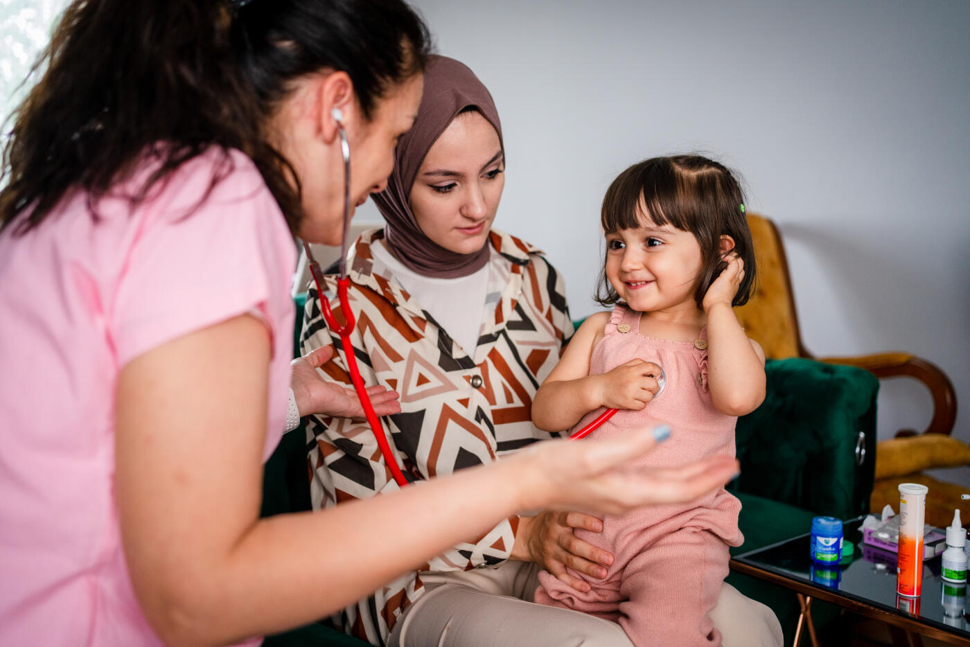 Doctor visit and examine by listen to heart of child girl patient at home