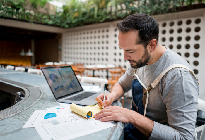 Business owner doing the books at a restaurant