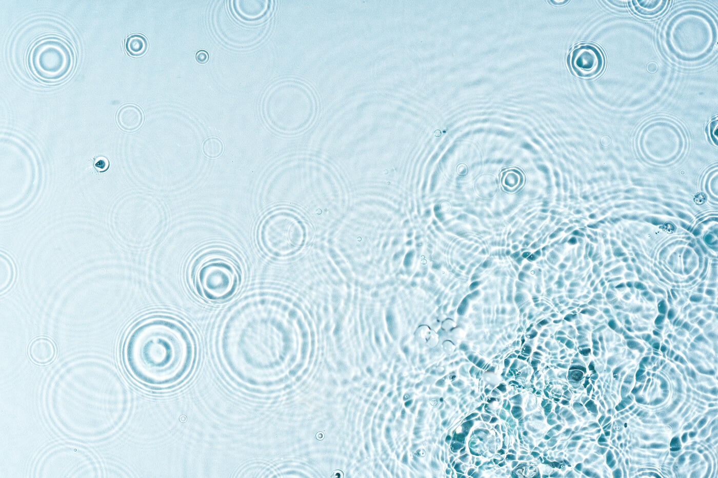 Gentle ripples form on a serene blue surface for background