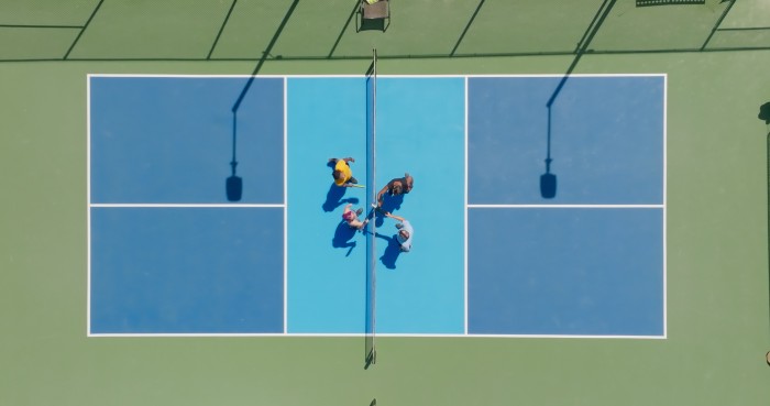 Pickleball Players Tapping Paddles Before Doubles Game - Top Down Aerial