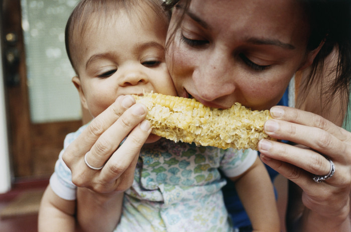 Mother and Baby Eating Corn