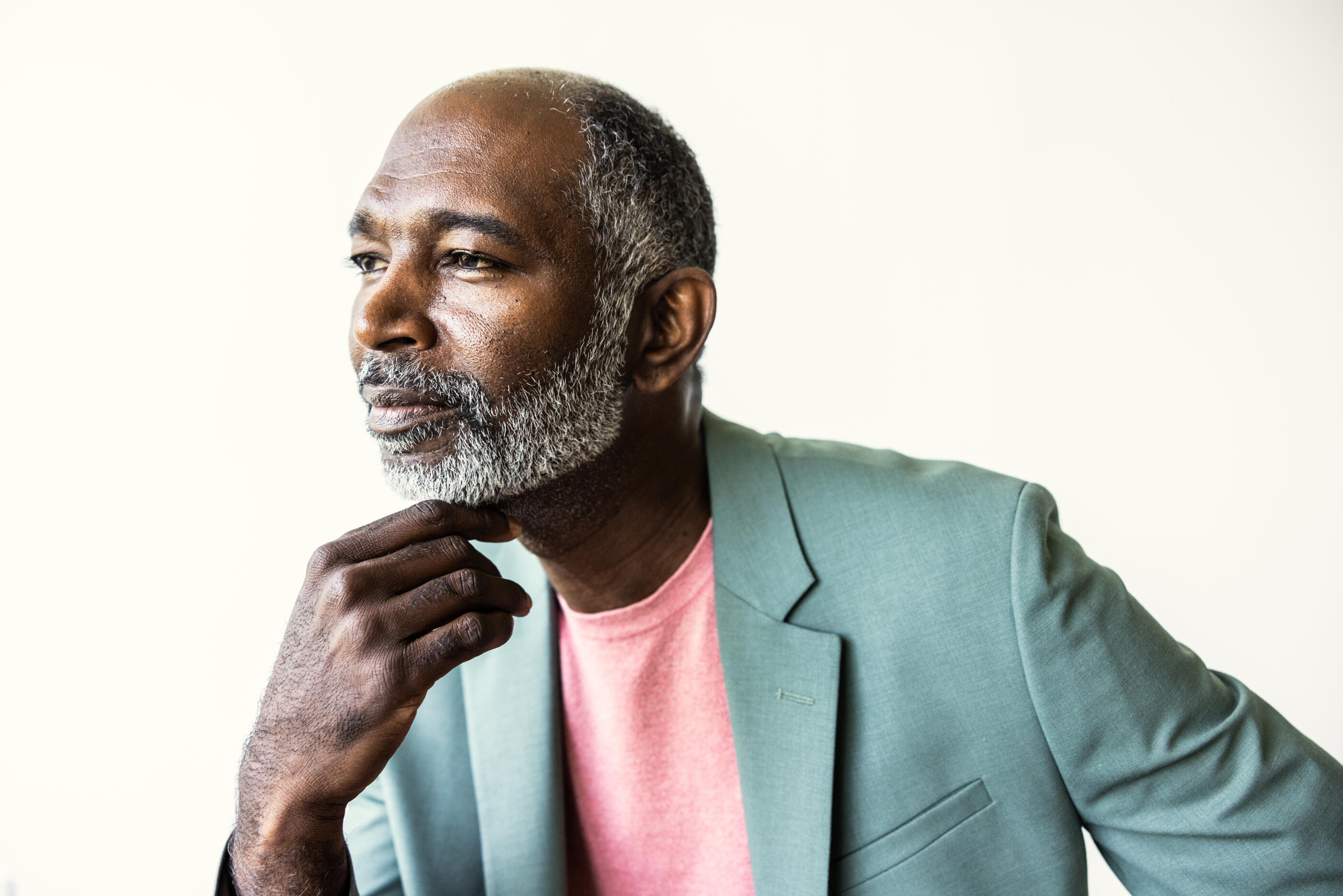 Portrait of fashionable senior man with gray hair on white background