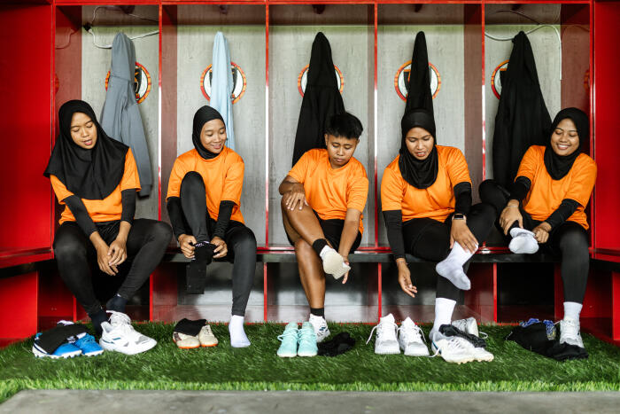Female soccer player, dressed in match-ready shoes, stands ready for the game