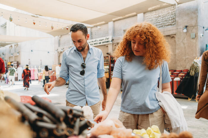 Tourists choosing spices at Dubai Spice Souk in Old Dubai