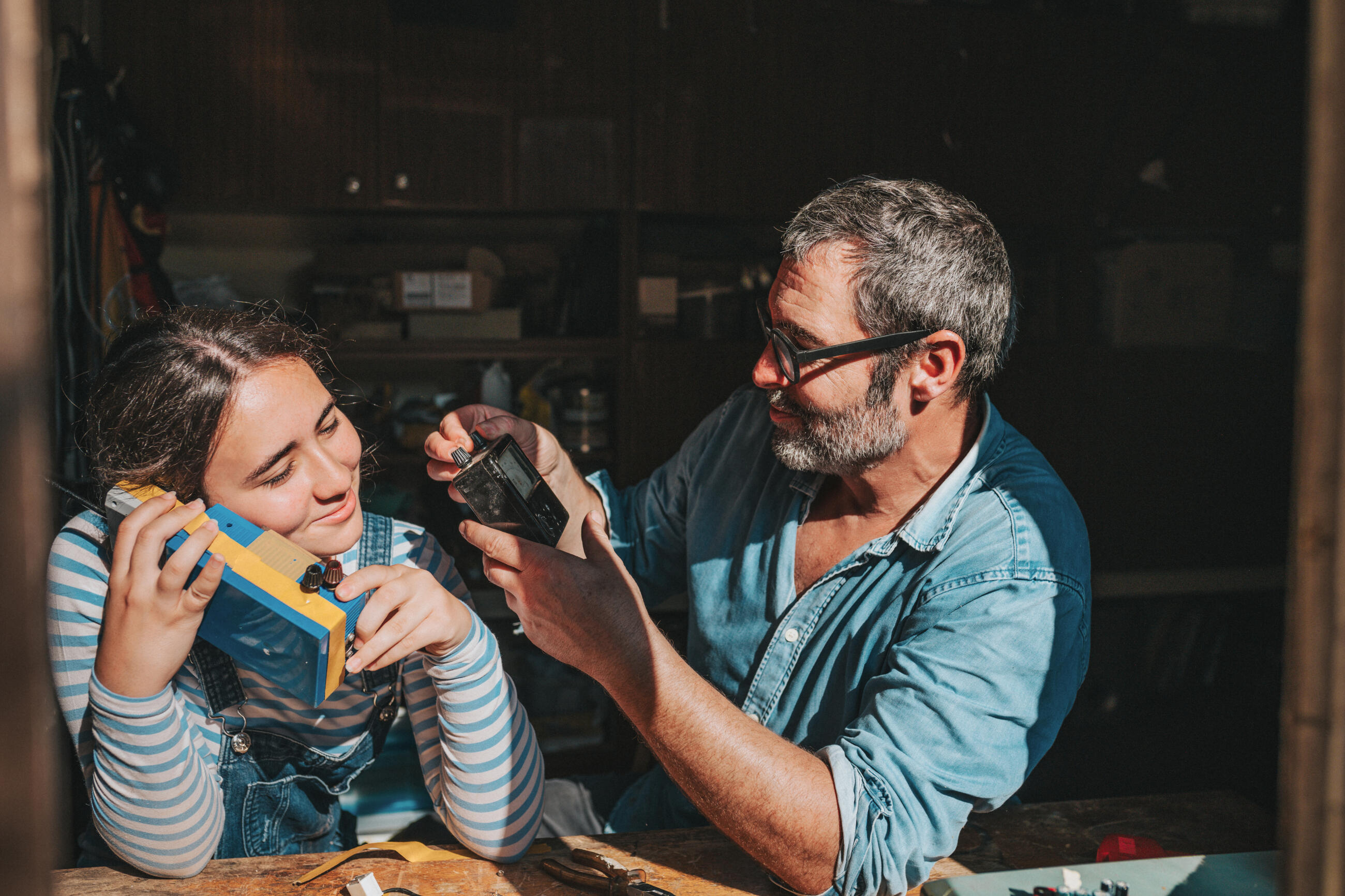 Vater und Tochter im Teenageralter haben Spaß mit Upcycling-Spielzeug in der Werkstatt