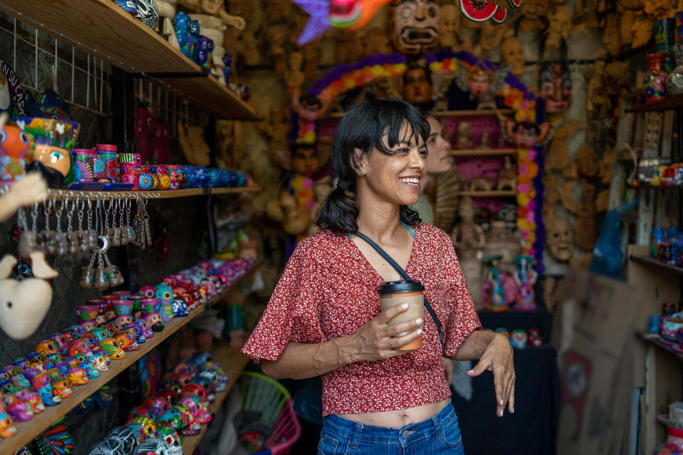 two women friends looking at and shopping  handicrafts and souvenirs at a street market in mexico