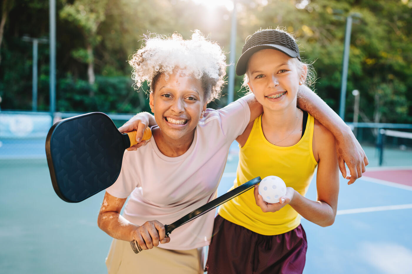 Portrait of friendly children playing pickleball