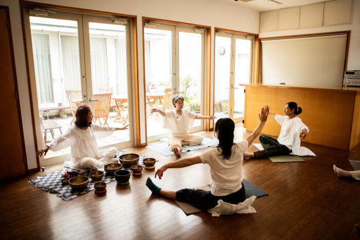 Women in the yoga community practicing yoga quietly and with concentration.