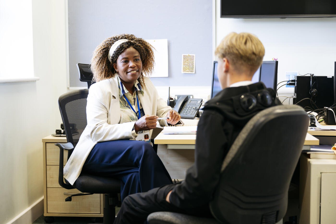 Mature woman with contented expression looking at school boy and providing emotional support