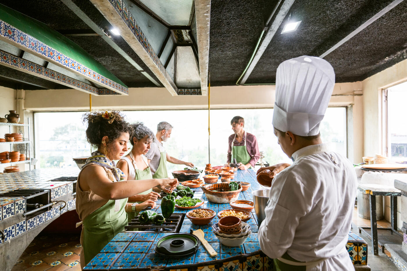 Chef shows tourists how to cook Chiles en Nogada a traditional Mexican dish