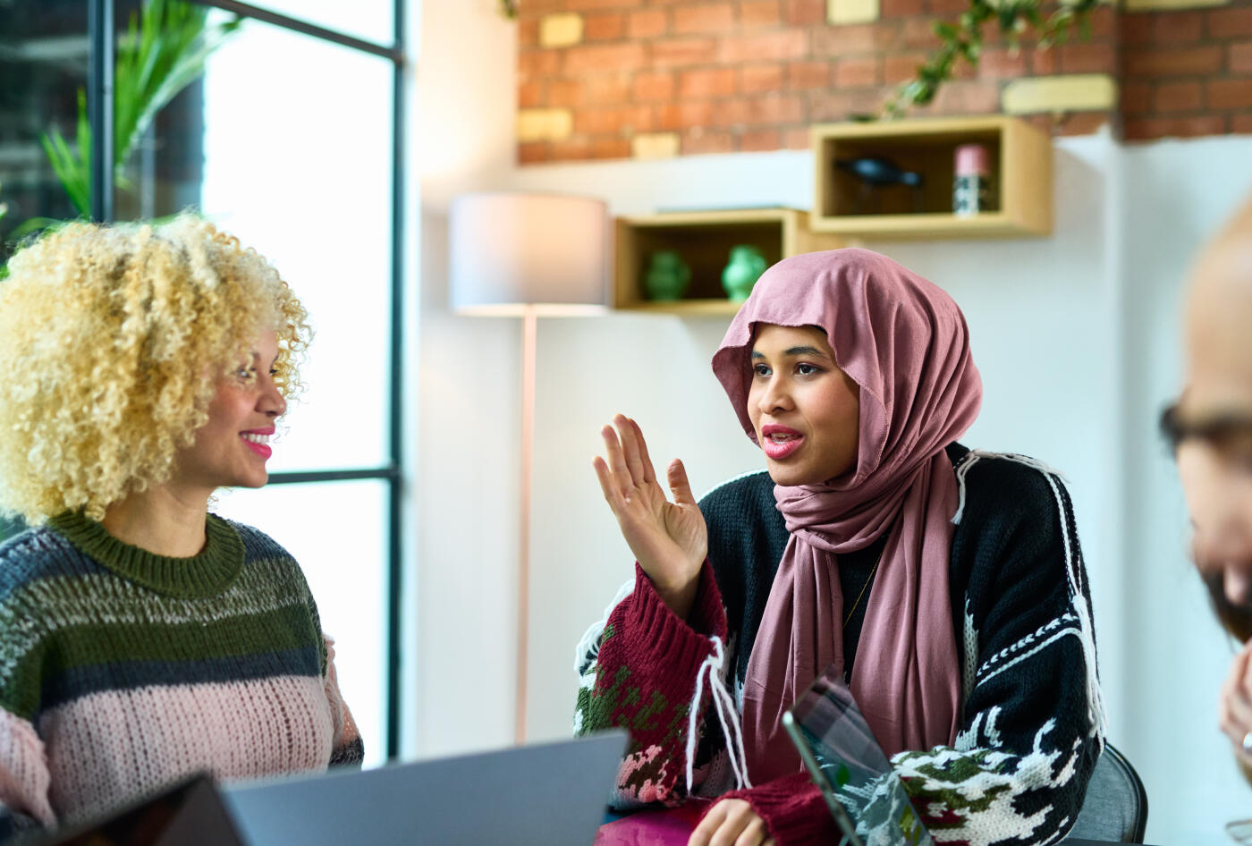 Confident young mixed race woman making her point in team meeting, leadership, direction, strategy