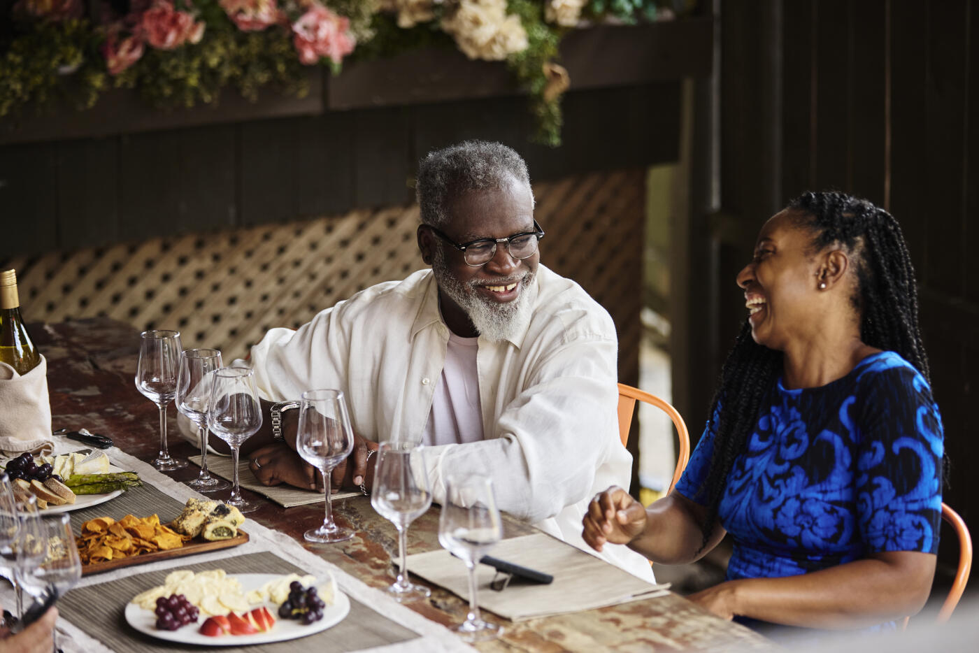 High-angle view of a mature couple enjoying appetizers at a wine bar.
