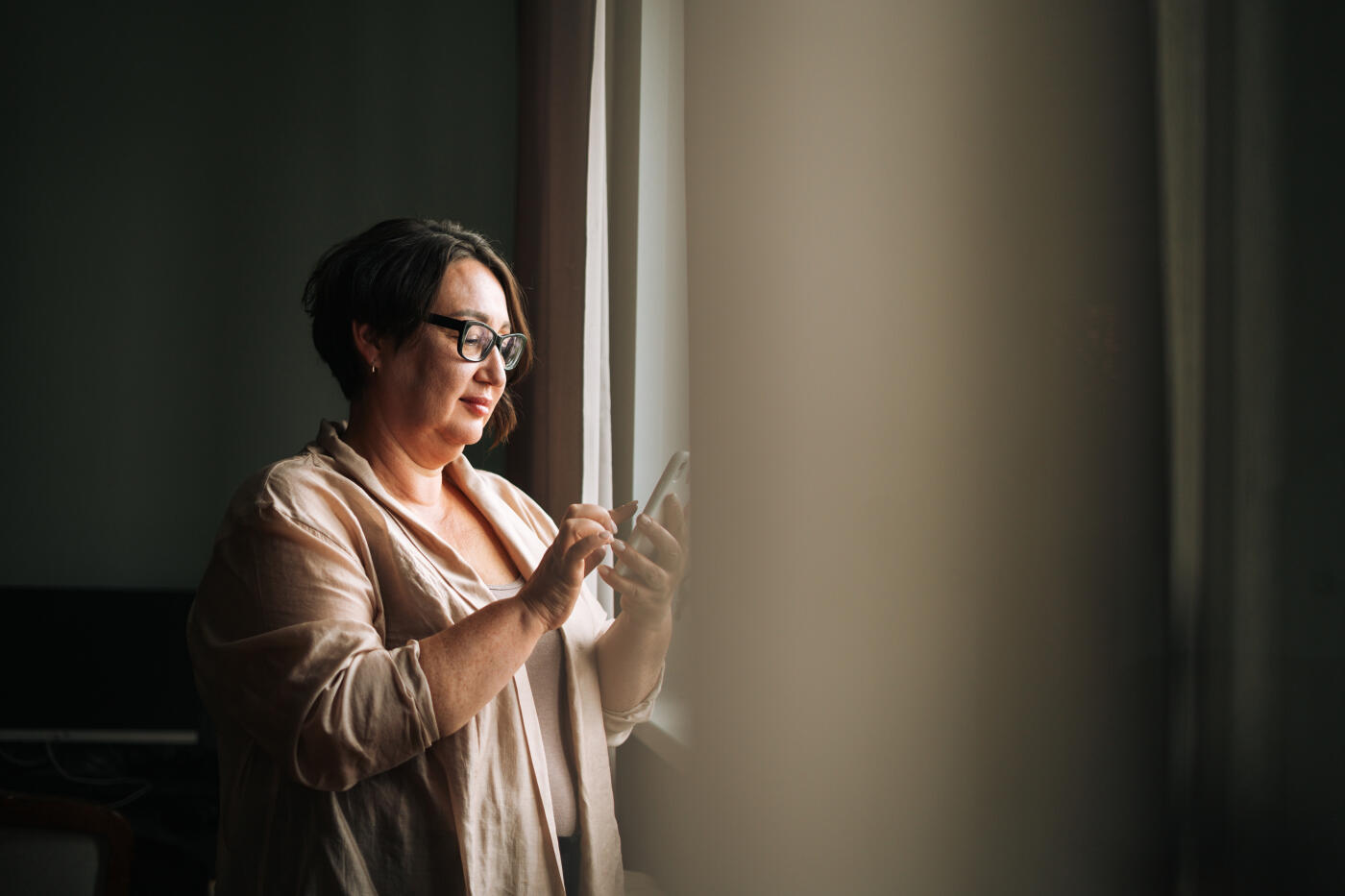Beautiful woman plus size using mobile phone at home