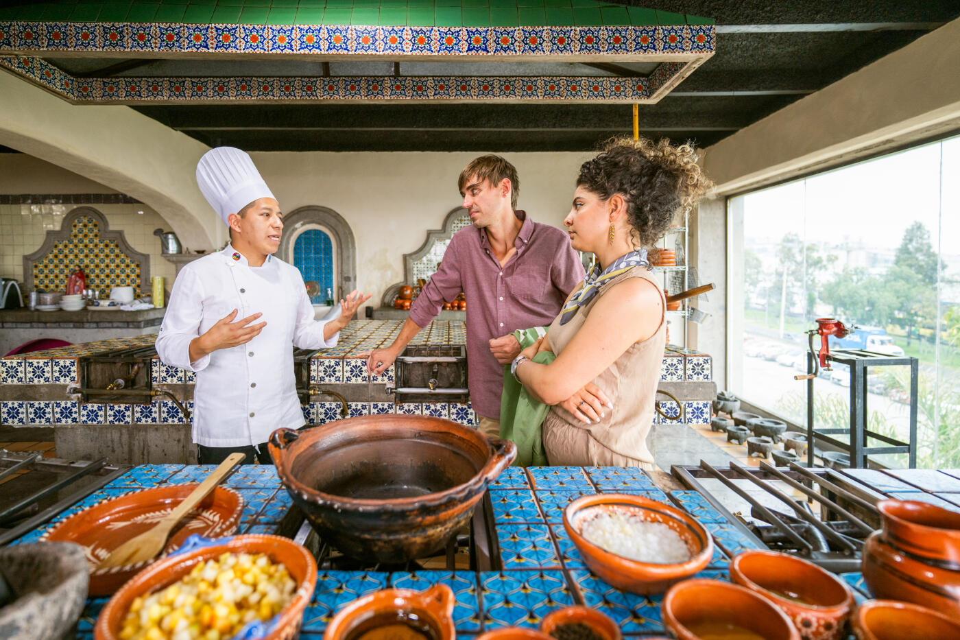 Chef shows tourists how to cook Chiles en Nogada a traditional Mexican dish