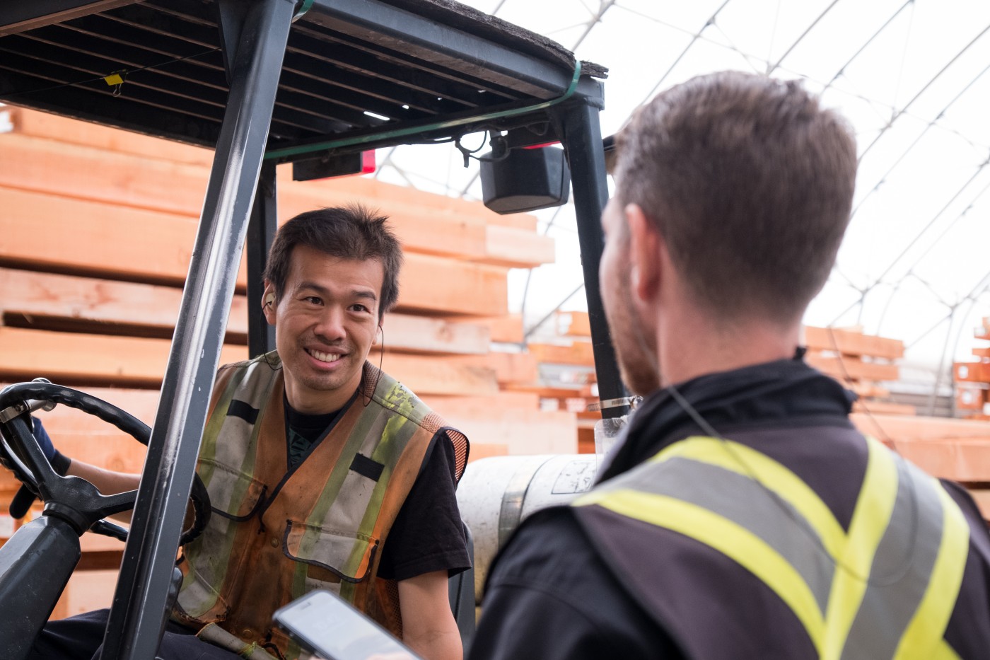 Men working together in a larger industrial timber factory.